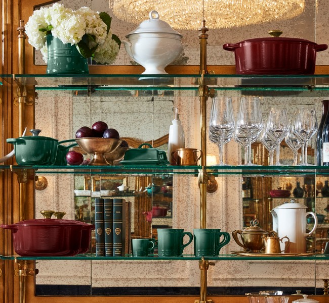 glas shelves filled with cookware in luxurious hues