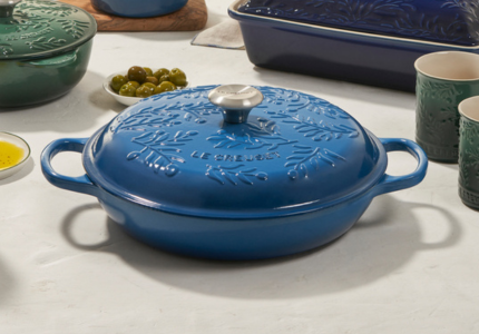 green saucepan with olive branch design embossed on lid