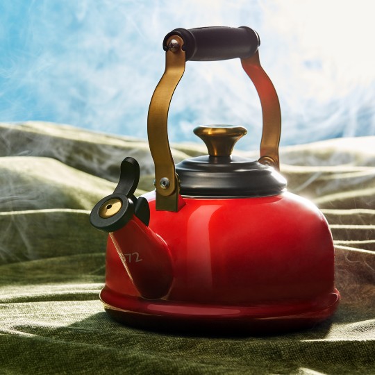 red kettle with a gold handle and platform 9 3/4 branding