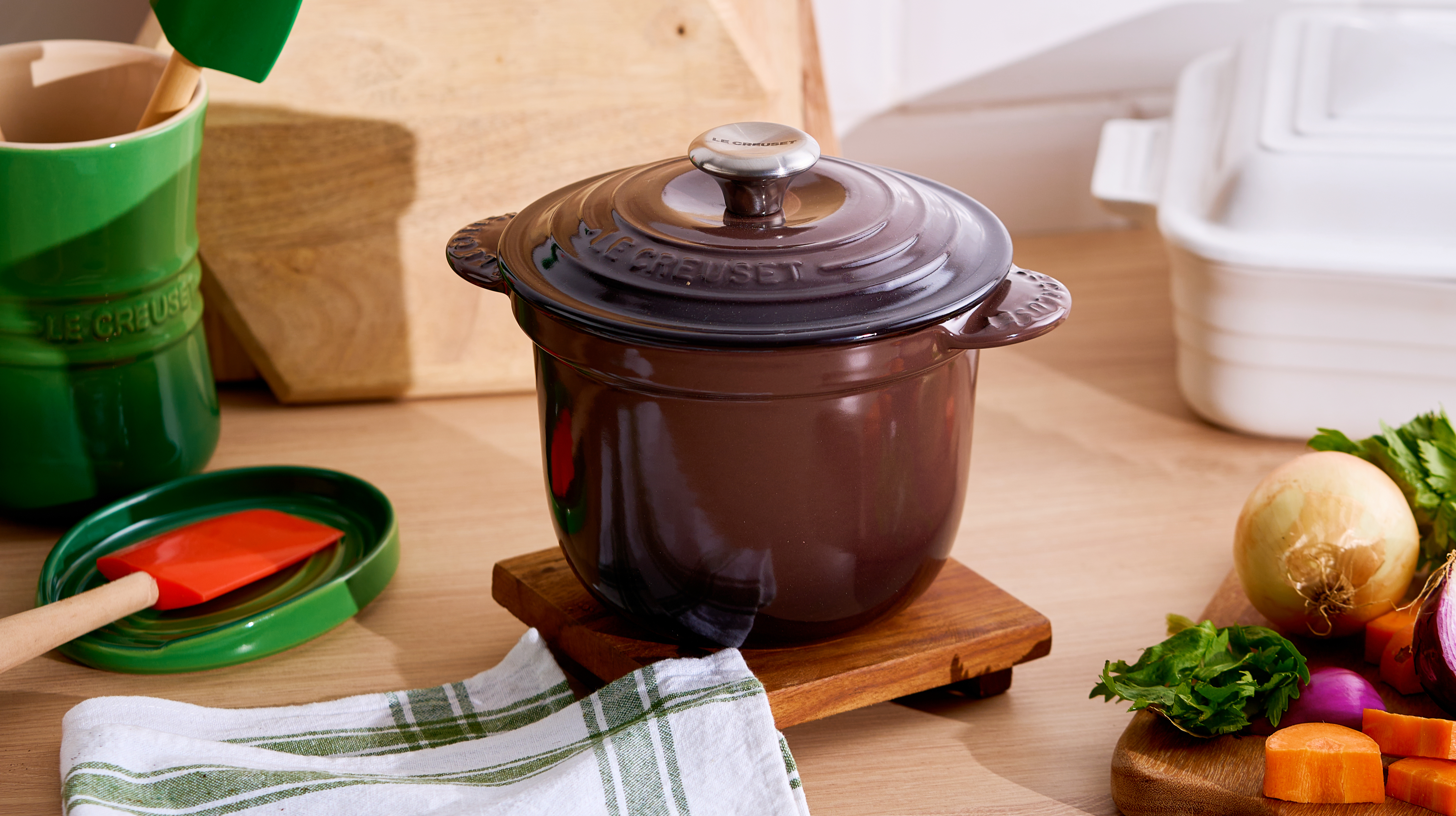 cookware in olive green, ganache brown and meringue on a shelf