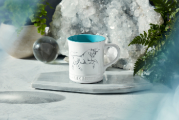 white mug with turquoise interior and bull design on side