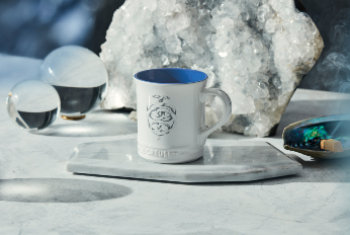 white mug with blue interior and gemini design on side