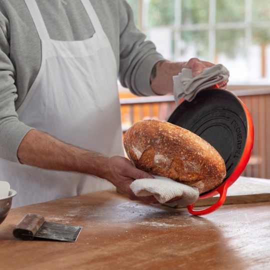 Chad Robertson tips bread out of a Le Creuset bread oven