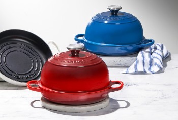 Le Creuset bread oven in caribbean blue with loaves of bread
