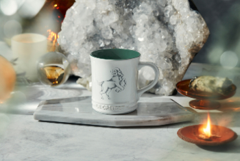 white mug with green interior anc ram design on side