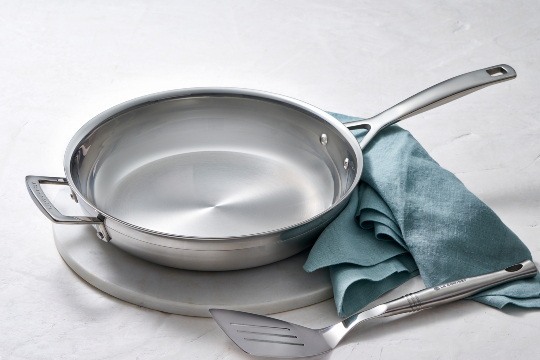 pork chops in a stainless steel fry pan