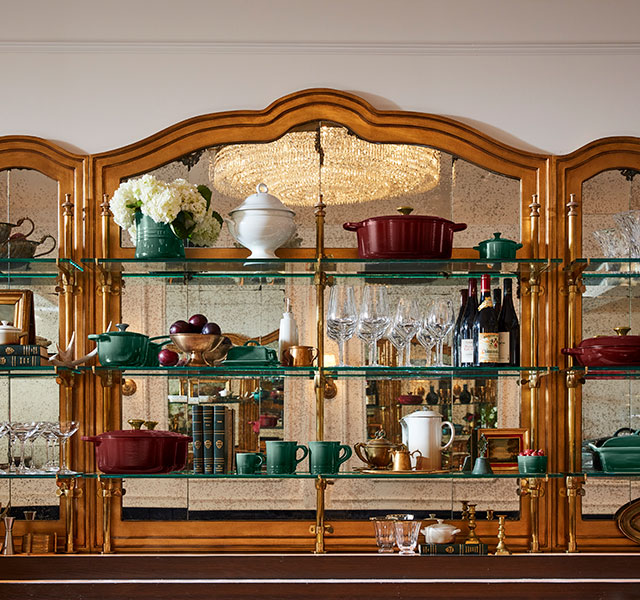 glas shelves filled with cookware in luxurious hues