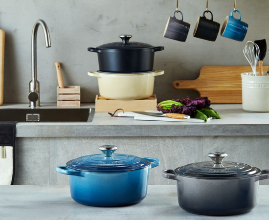 oyster gray on shelves featuring an array of vibrant Le Creuset colors