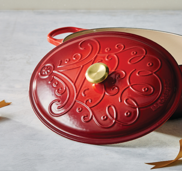 red platter with an embossed design of santa's face