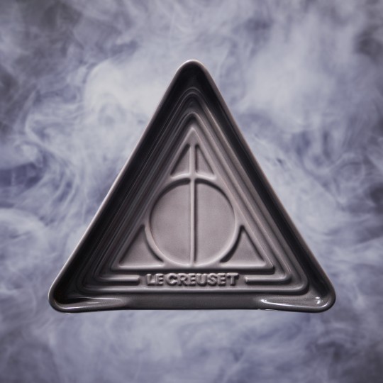 simple triangular spoon rest featuring the symbol for the deathly hallows embossed on the surface