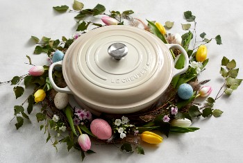 a person works with dough in a Le Creuset bread oven