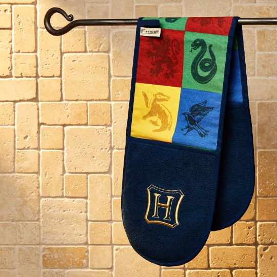 long, two handed potholder featuring the logos of all 4 hogwarts houses