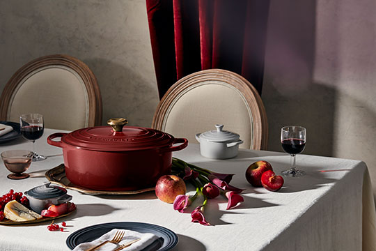 Thanksgiving table set with red wine colored cookware