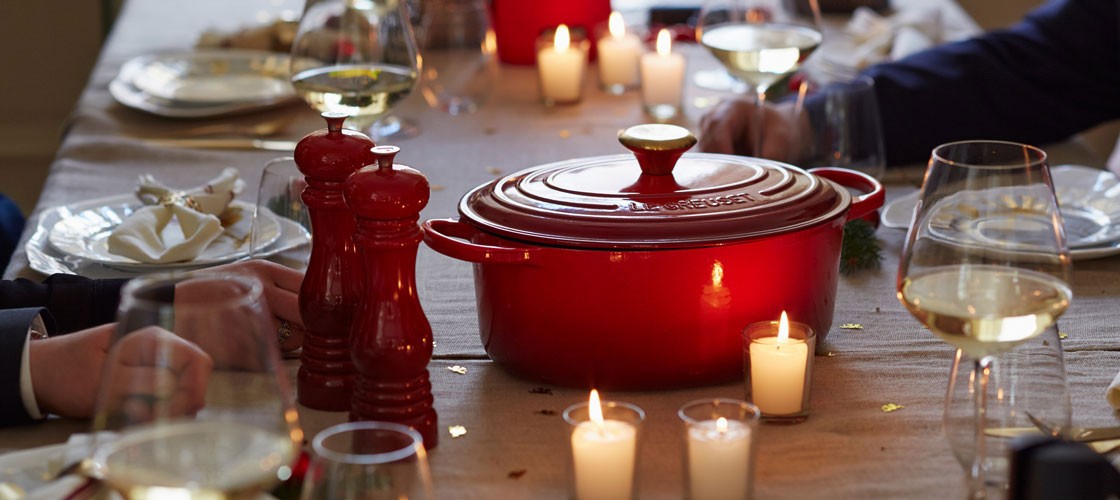 a festive dinner table with candles and holiday decor